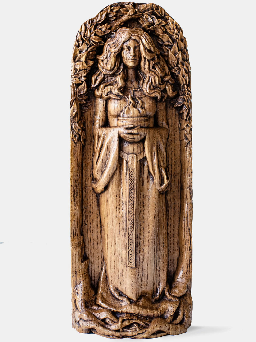 Close-up of the handcrafted oak Bridget statue, showcasing detailed carvings of a bowl of fire and thick curly hair.