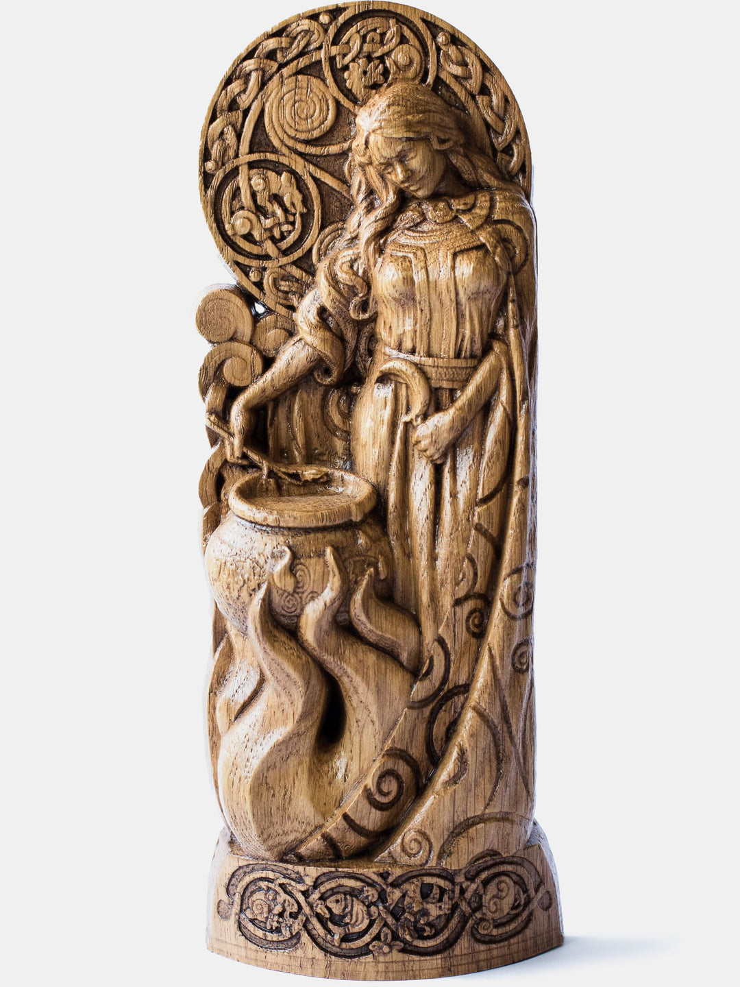 Close-up of the handcrafted oak Ceridwen statue, showcasing detailed carvings of the goddess brewing a potion with three drops running down the cauldron.