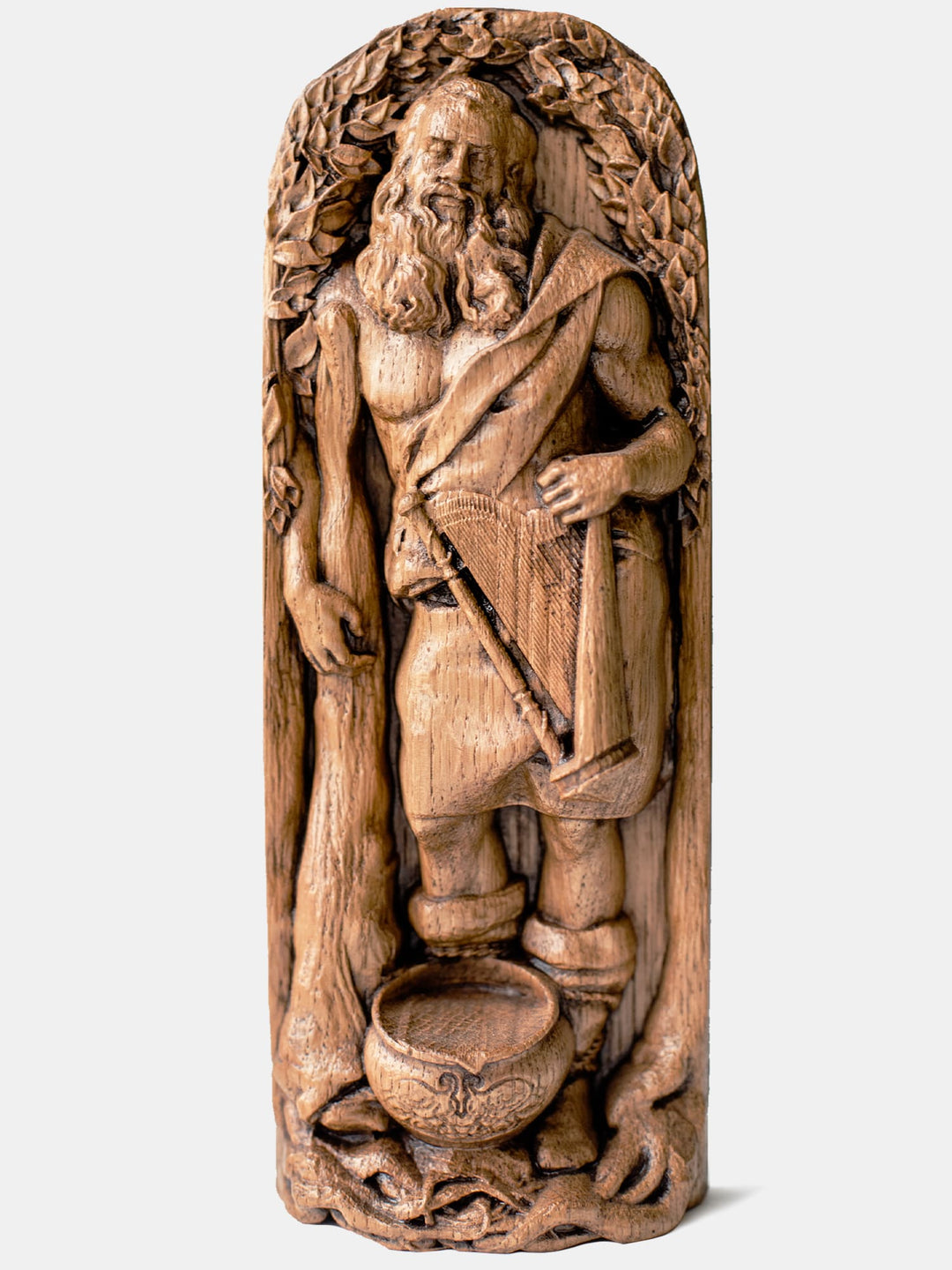 Close-up of the handcrafted oak Dagda statue, showcasing detailed carvings of Dagda holding his magical club and cauldron.