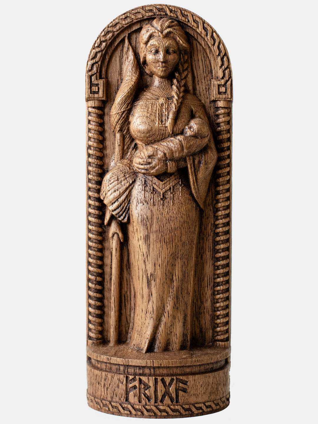 Close-up of the handcrafted oak Frigg statue, showcasing detailed carvings of Frigg with a spindle, keys, and a child in her arms.