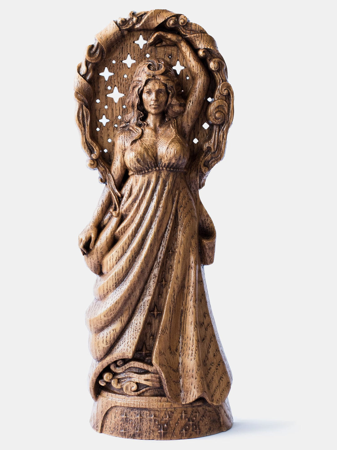 Close-up of the handcrafted oak Nyx statue, showcasing the goddess with stars cut through the wood to shine against the dark background.
