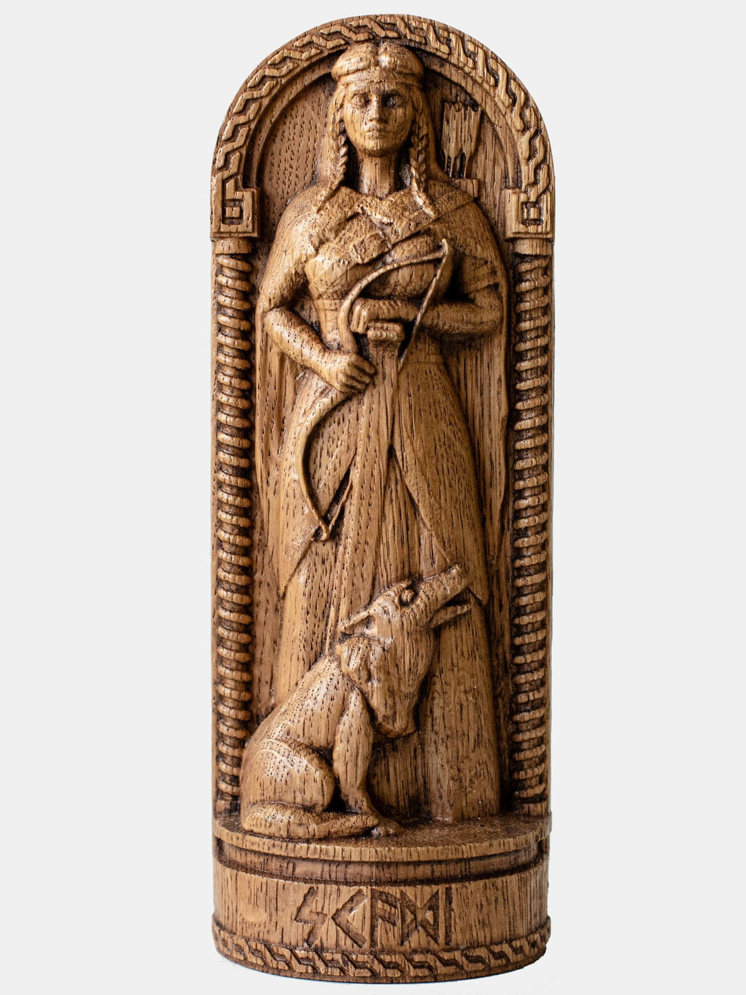 Close-up of the handcrafted oak Skadi statue, showcasing the Norse Goddess holding a bow and skis, with a wolf beside her.