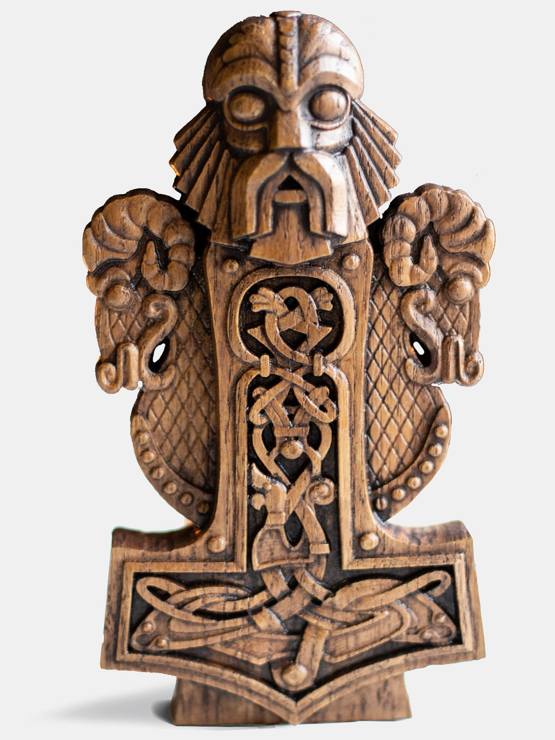 Close-up of the handcrafted oak Thor bust, showcasing the Norse God of Thunder with intricate Scandinavian knot patterns, Mjolnir, and his goats.