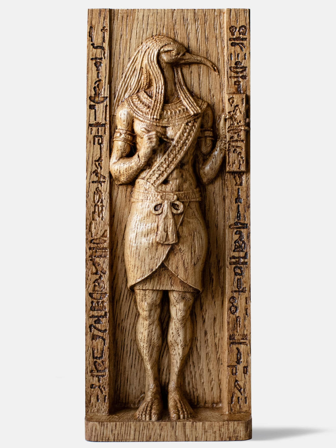 Close-up of the handcrafted oak Thoth statue, showcasing the Egyptian God of Wisdom with an ibis head, holding a scribe’s palette and stylus.