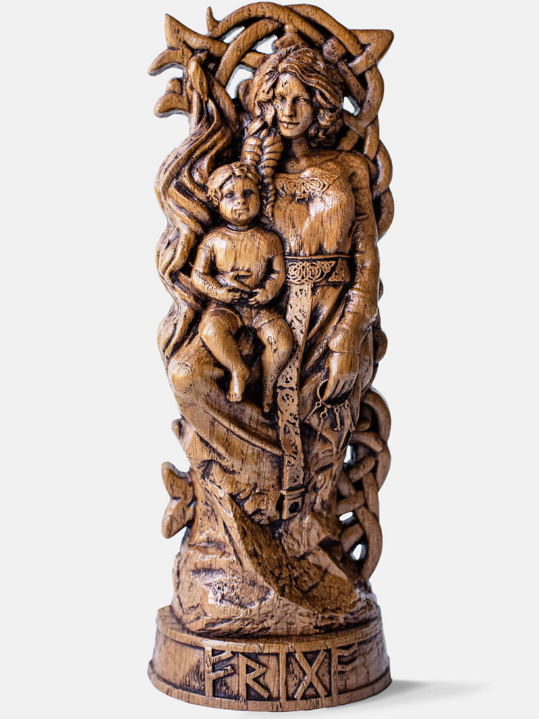 Close-up of the handcrafted oak Frigg statue, showcasing detailed carvings of Frigg with a spindle, keys, and a child in her arms.