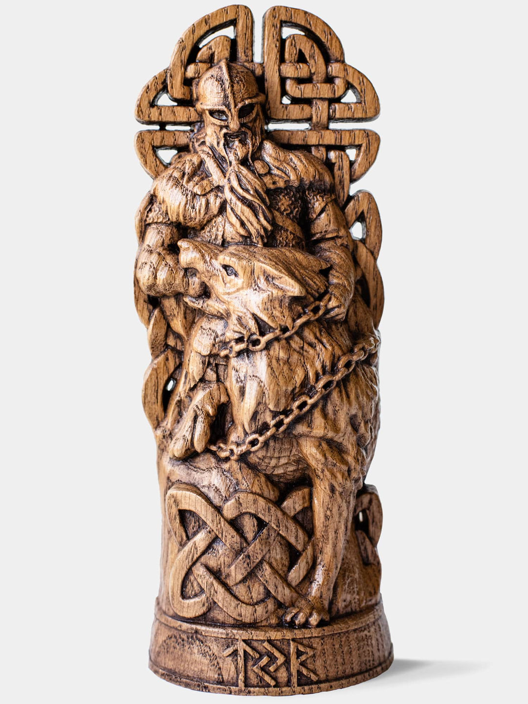Close-up of the handcrafted oak Týr and Fenrir statue, showcasing Týr placing his hand into Fenrir's mouth while the wolf is being chained.