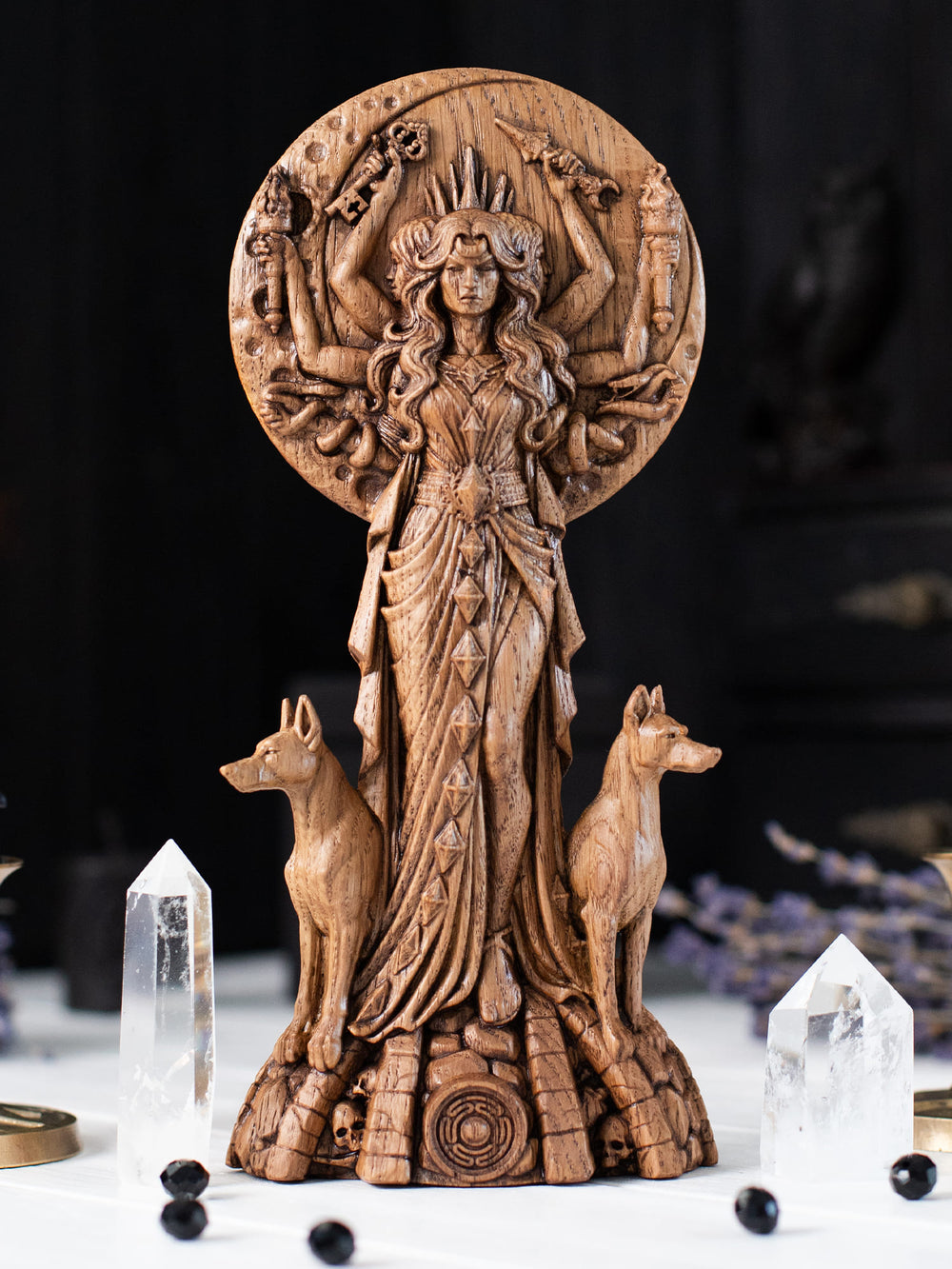 Wooden Hekate figurine with full moon backdrop, sacred tree silhouette and Key of Hecate at her feet