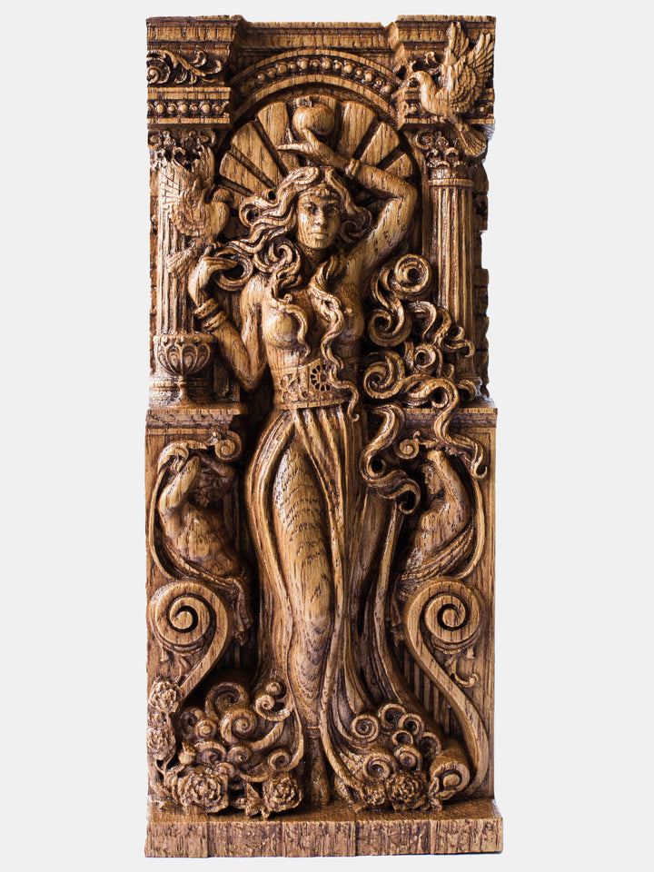 Close-up of the handcrafted oak Aphrodite statue with naked bust, showcasing detailed carvings, including an apple and sea foam.
