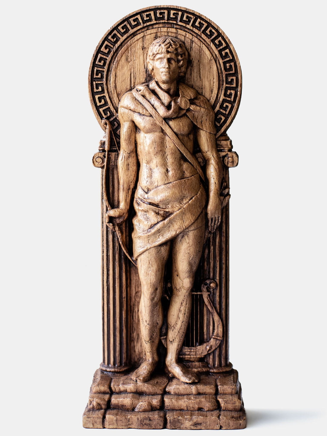 Close-up of the handcrafted oak Apollo statue, showcasing detailed carvings, including a lyre and laurel leaves.