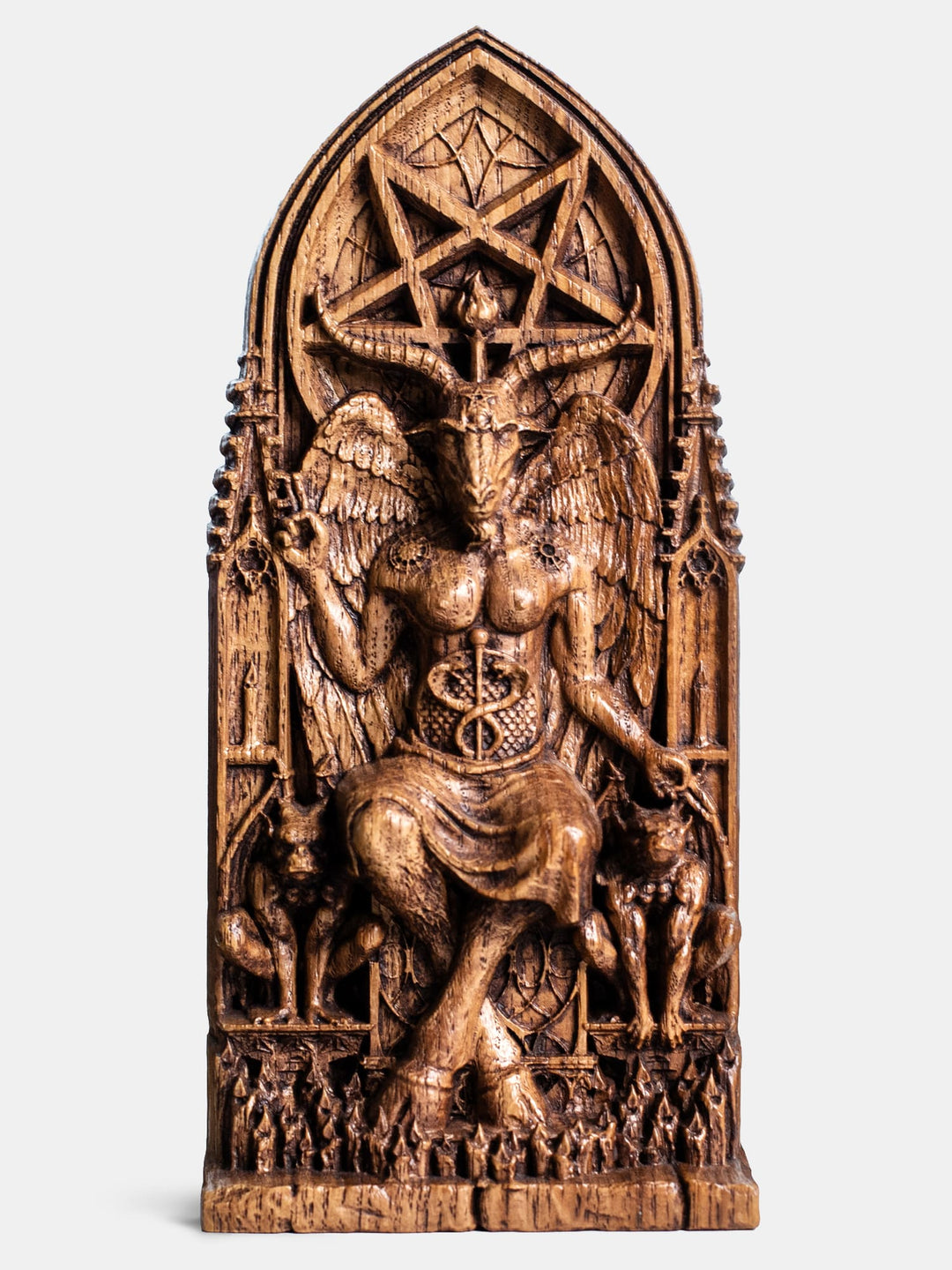 Close-up of the handcrafted oak Baphomet statue, showcasing detailed carvings of gargoyle statues and lit candles.