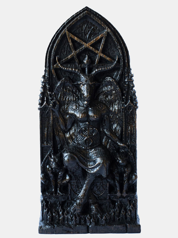 Close-up of the handcrafted wooden Baphomet blak color statue, showcasing detailed carvings of gargoyle statues and lit candles.