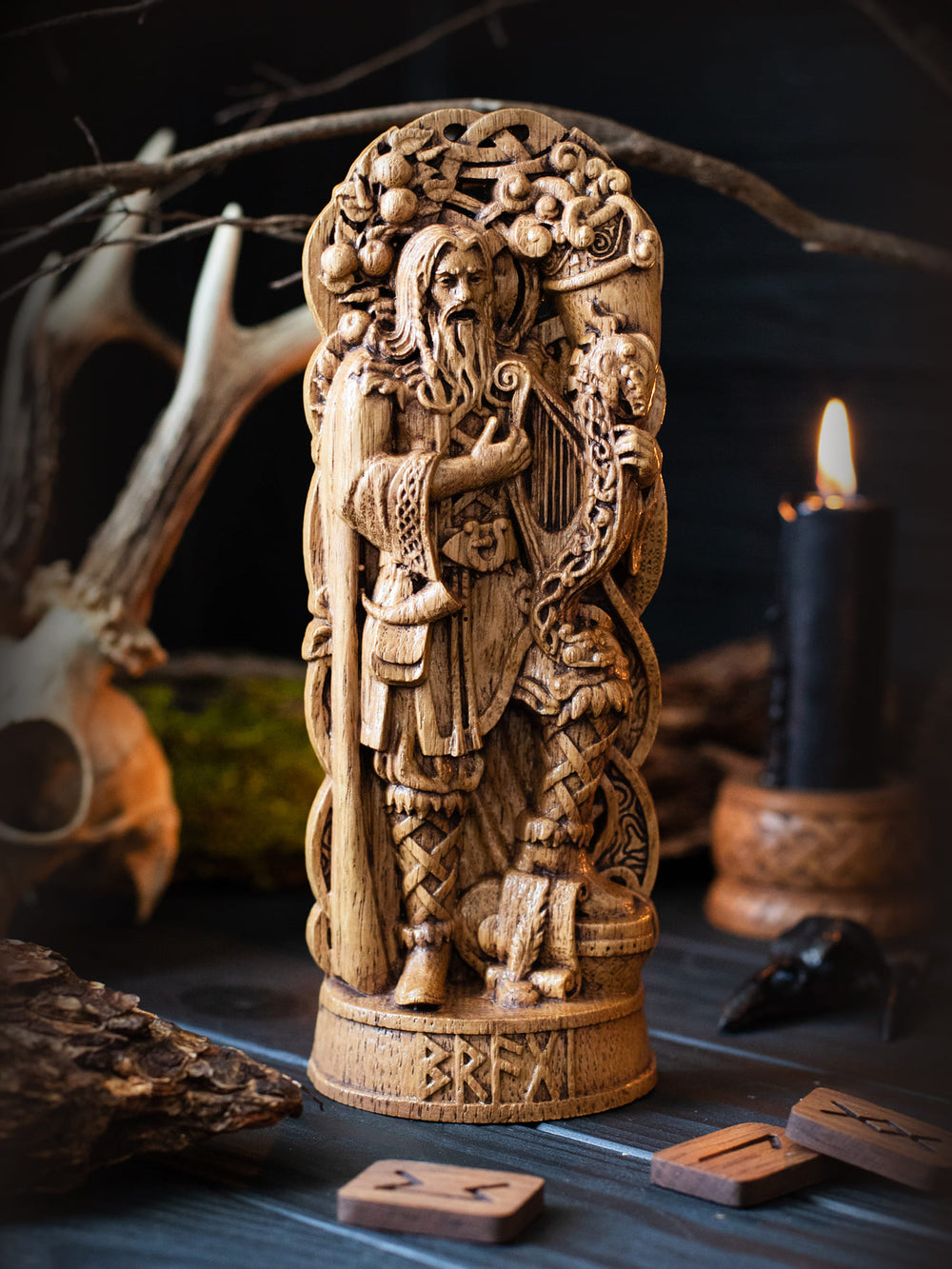 Full view of the Bragi statue from the front, highlighting its dimensions and intricate design, featuring a drum, paper, quill, horn of honey, and an apple tree.