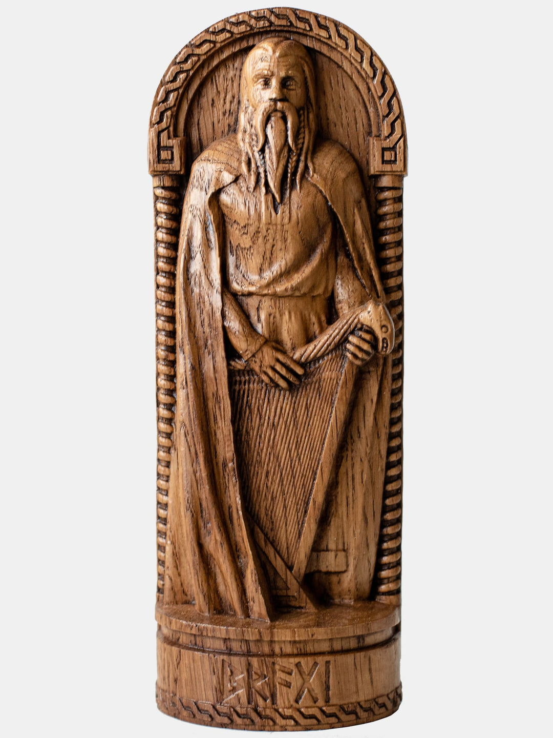 Close-up of the handcrafted oak Bragi statue, showcasing detailed carvings of Bragi holding a musical instrument.