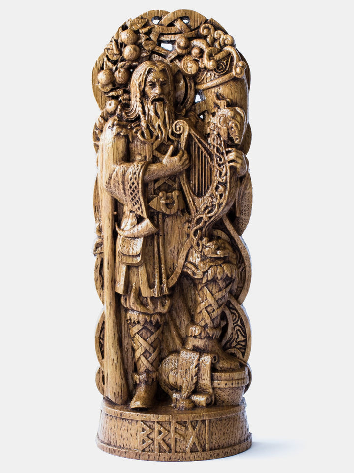 Close-up of the handcrafted oak Bragi statue, showcasing detailed carvings of Bragi singing and playing a musical instrument.