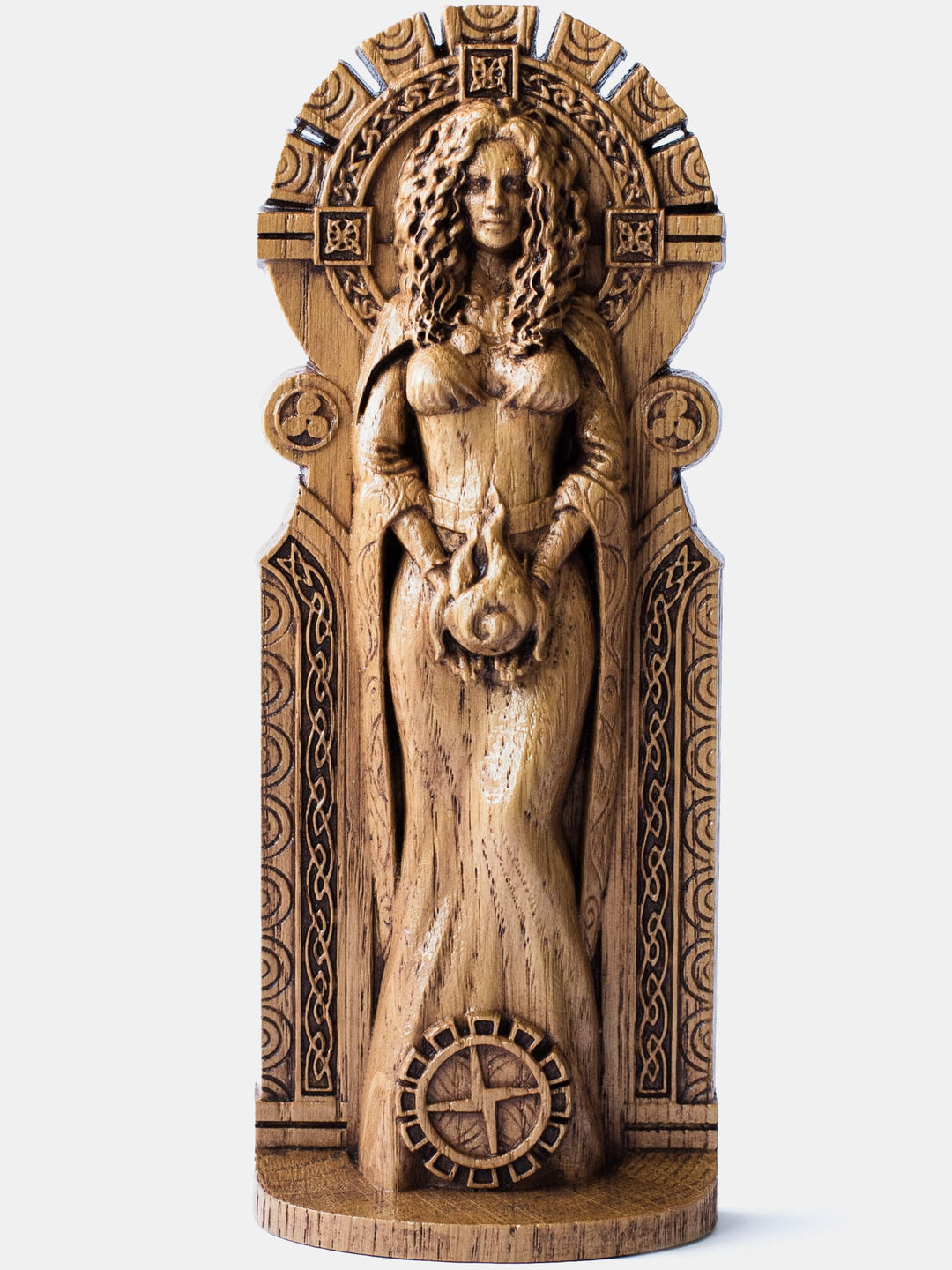 Brigid the Flame oak figurine depicting the Celtic goddess holding fire in her hands with a Brigid's cross at her feet.