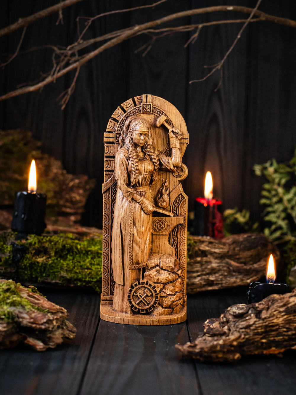 Detailed statue of Brigid the Smith with tools at her feet, symbolizing craftsmanship and creativity.
