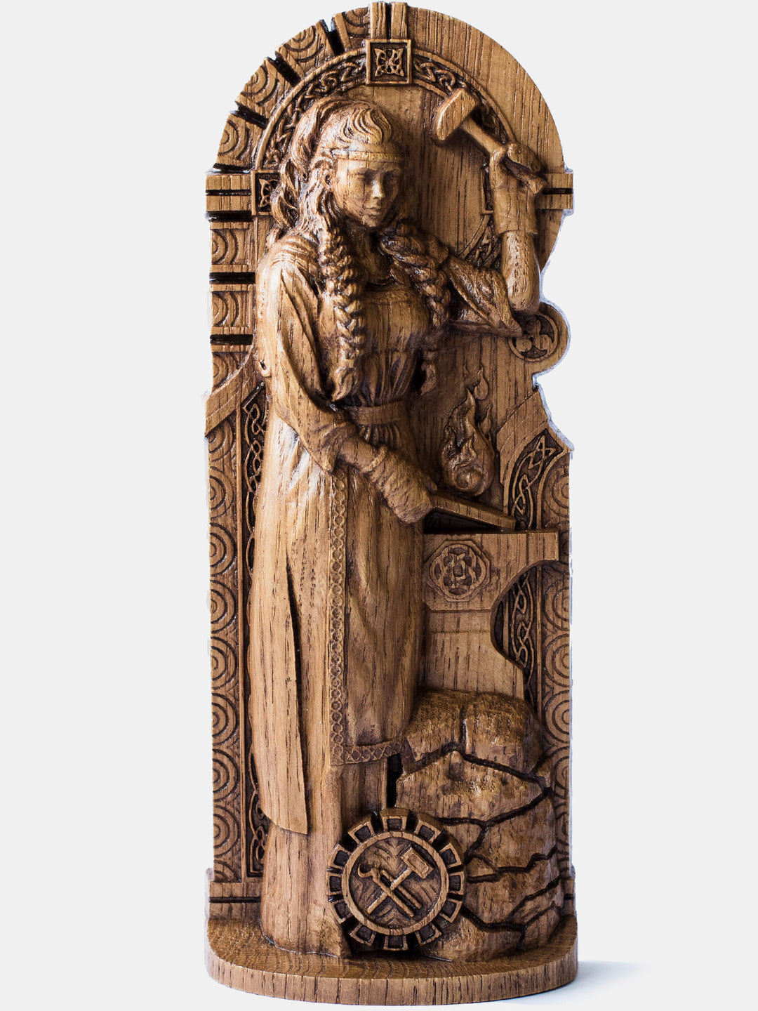 Brigid the Smith oak figurine depicting the Celtic goddess behind an anvil with a hammer in her hands.
