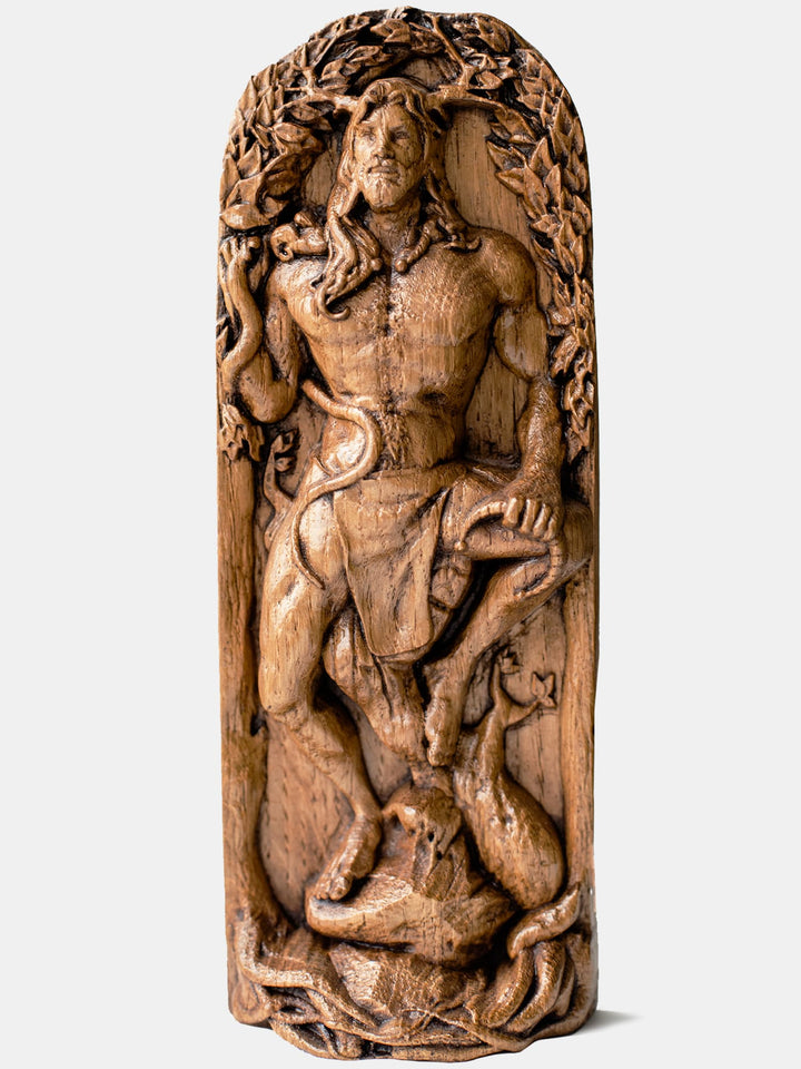 Close-up of the handcrafted oak Cernunnos statue, showcasing detailed carvings of Cernunnos holding a snake and a torc.