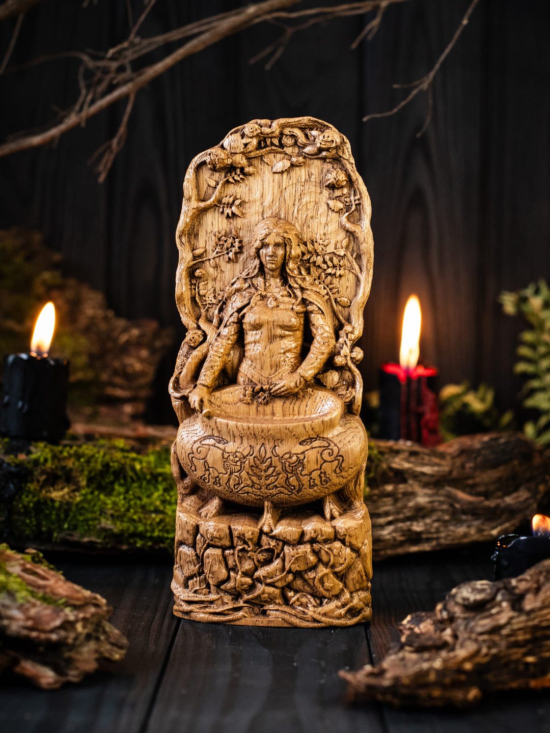 Full view of the Ceridwen statue from the front, highlighting its dimensions and intricate design, surrounded by lush bushes.