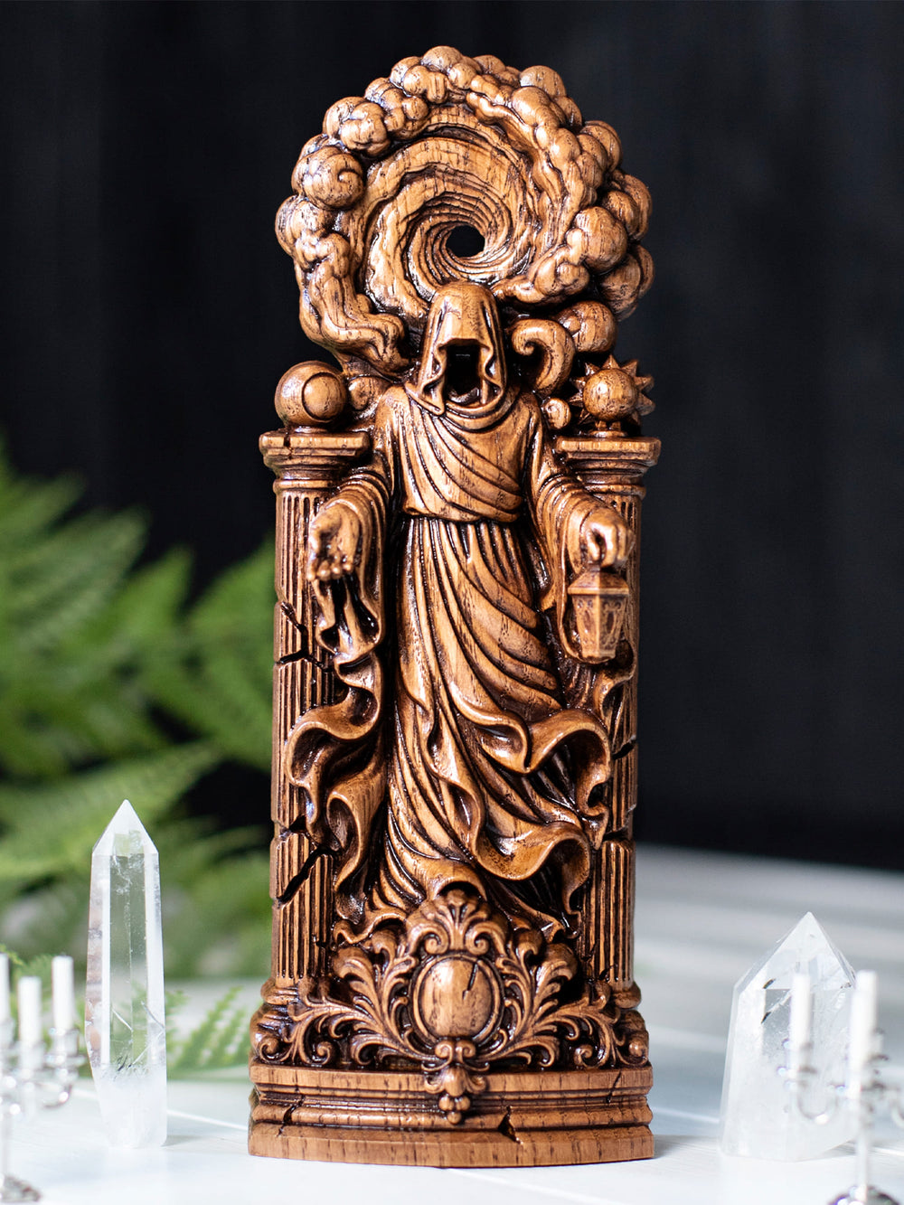 Wooden Greek goddess Chaos figurine featuring spiral void backdrop, celestial symbols, and ancient broken columns