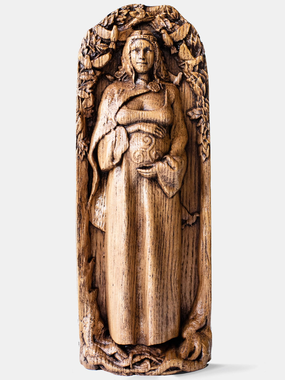 Close-up of the handcrafted oak Danu statue, showcasing detailed carvings of Danu with flowing robes and a serene expression.