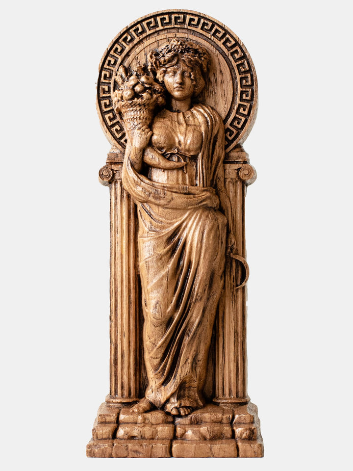  Close-up of the handcrafted oak Demeter statue, showcasing detailed carvings of Demeter holding a sickle and Cornucopia.