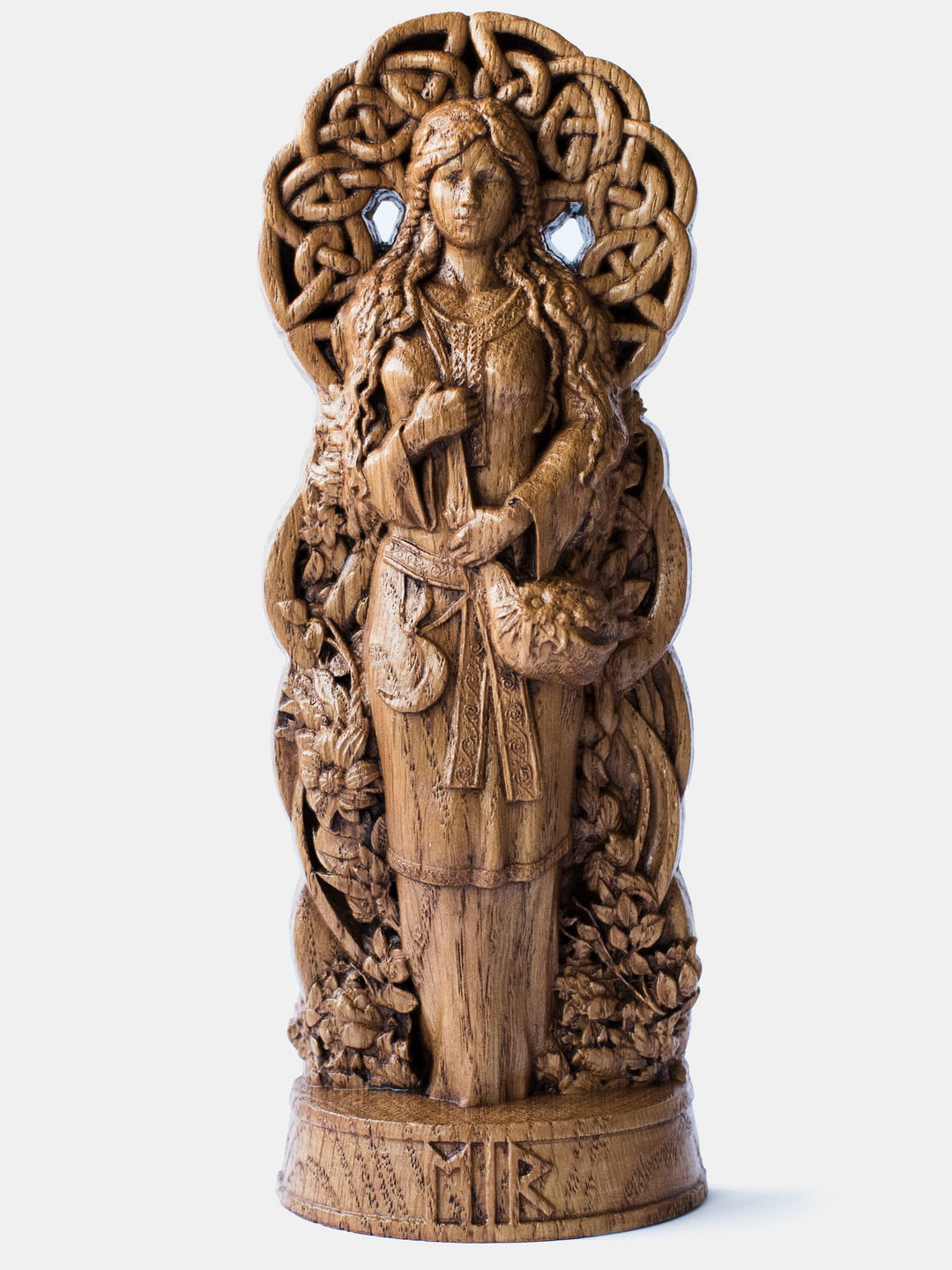 Close-up of the handcrafted oak Eir statue, showcasing detailed carvings of Eir holding a bag of medicinal plants and a sickle.