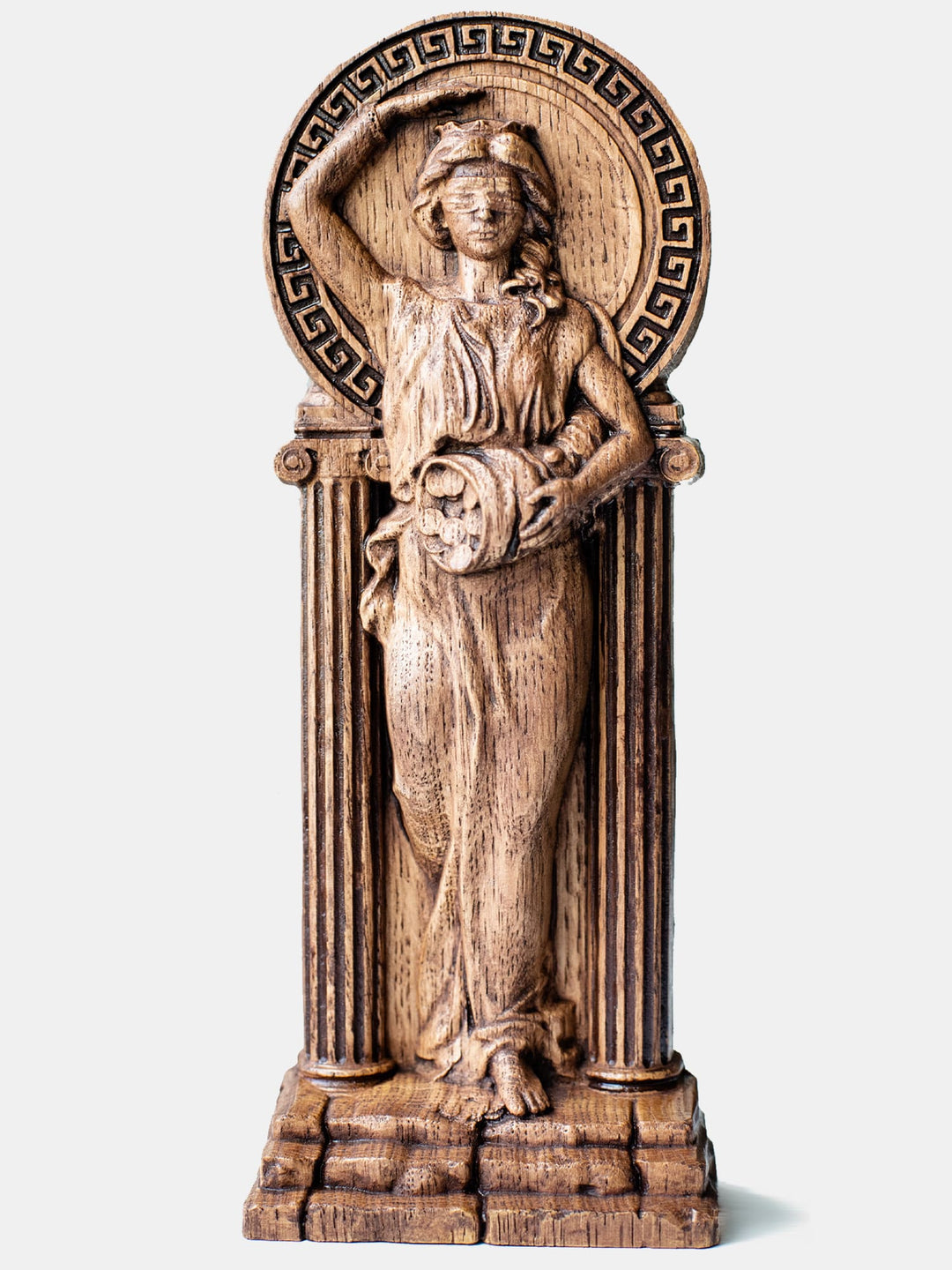 Close-up of the handcrafted oak Fortune statue, showcasing detailed carvings of the blindfolded goddess holding a money-filled cornucopia.