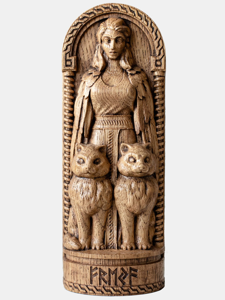 Close-up of the handcrafted oak Freya statue, showcasing detailed carvings of Freya with her two cats.