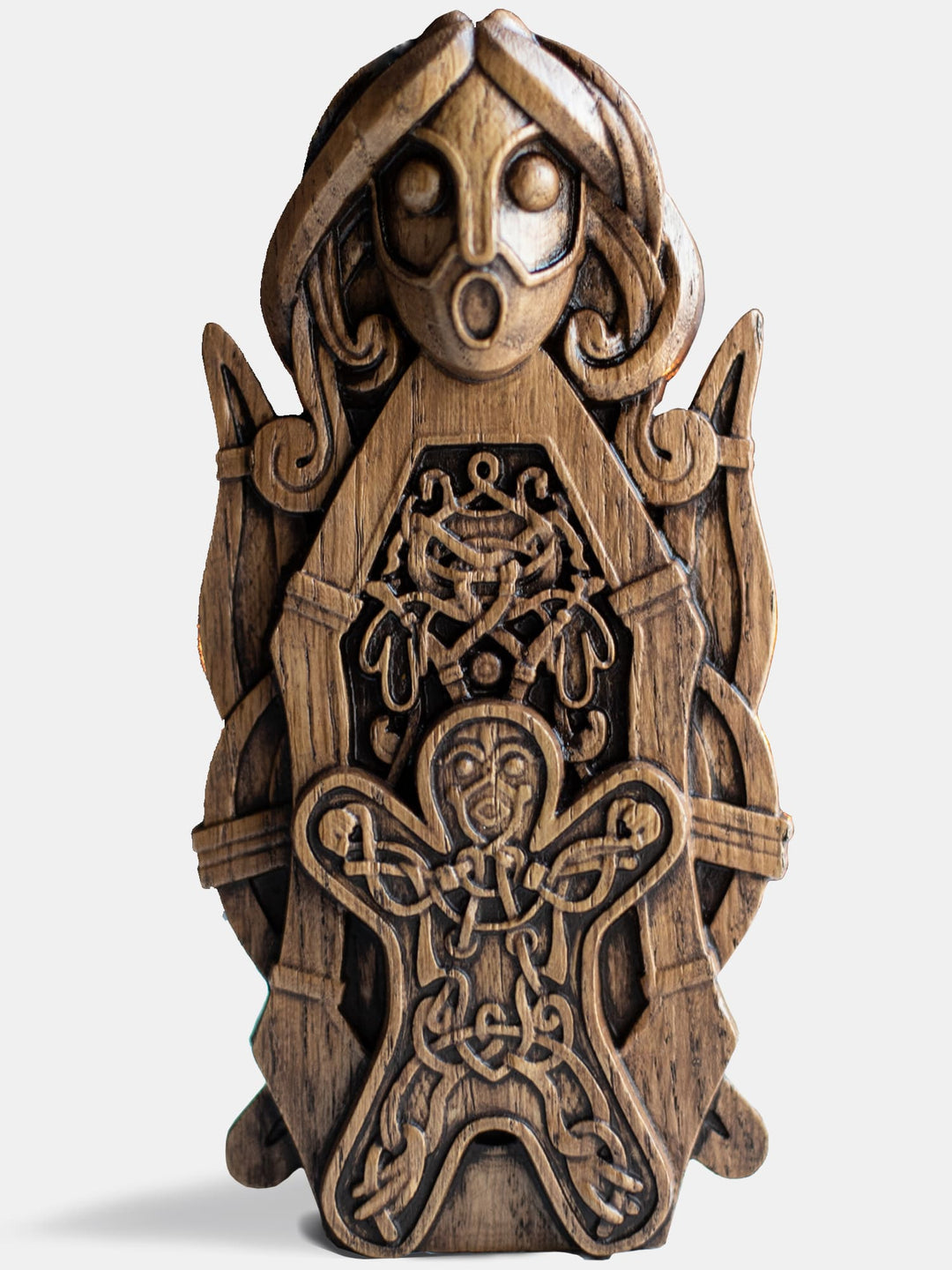 Close-up of the handcrafted oak Frigg statue, showcasing intricate Scandinavian carvings, flanked by a spindle with a child in front.