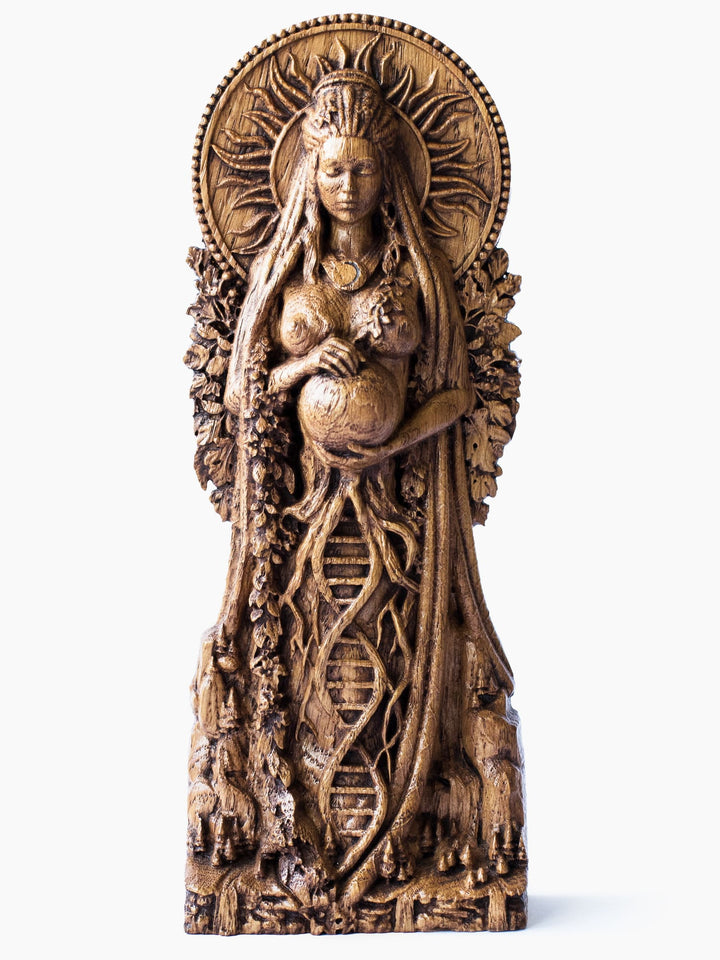 Close-up of the handcrafted oak Gaia statue, showcasing Gaia embracing Earth with the sun behind her and the moon on her chest.