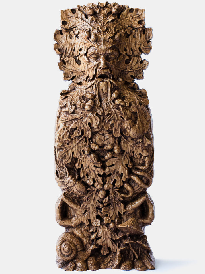 Close-up of the handcrafted oak Green Man bust, showcasing detailed carvings of oak leaves, acorns, and the Green Man’s mudra.