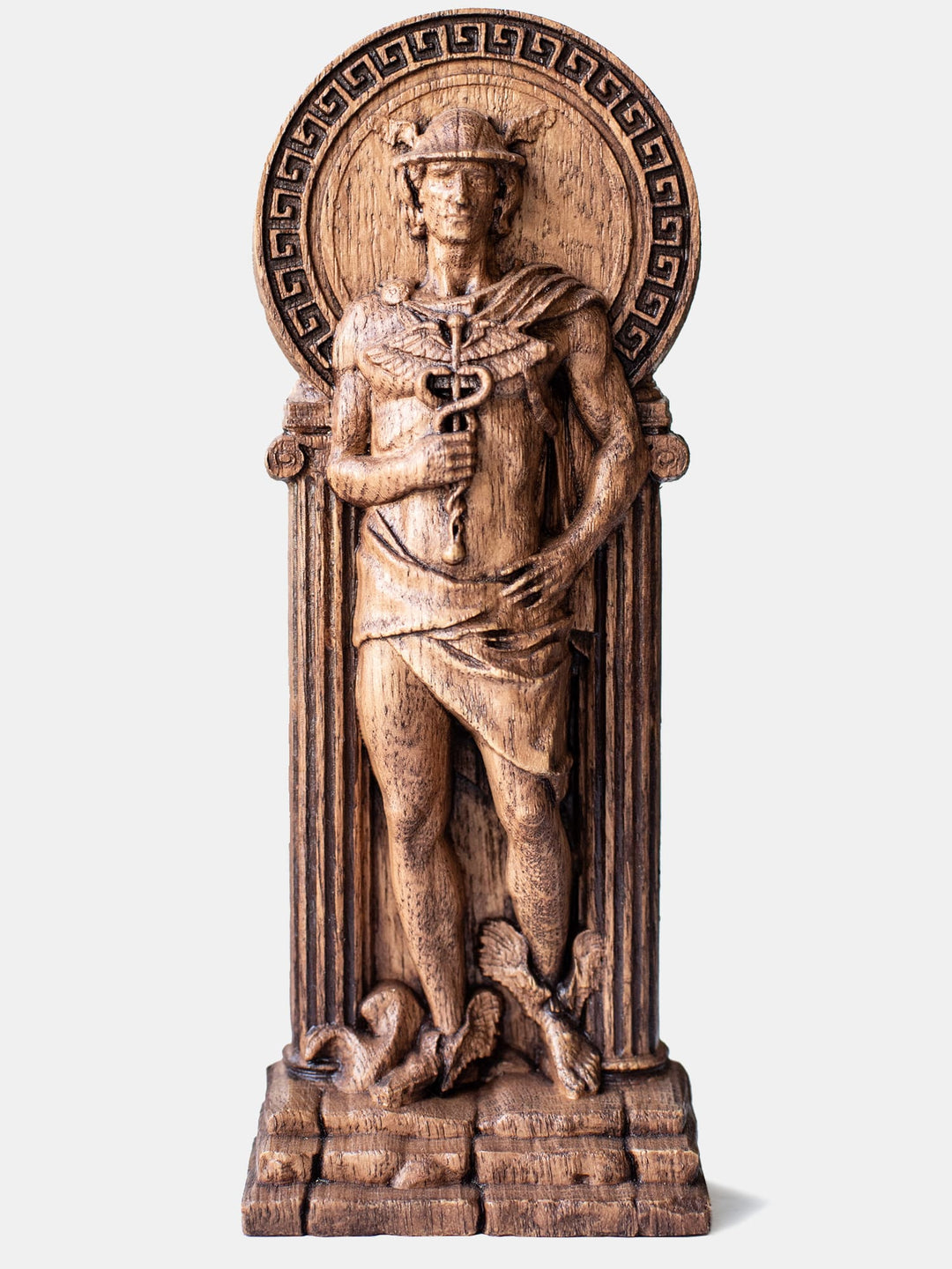 Close-up of the handcrafted oak Hermes statue, showcasing detailed carvings of Hermes with his helmet, winged sandals, and caduceus.