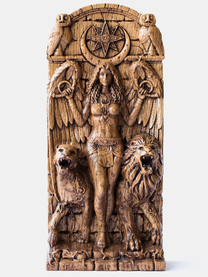 Close-up of the handcrafted oak Ishtar statue, showcasing the winged goddess holding sacred symbols with the moon and star above her head.