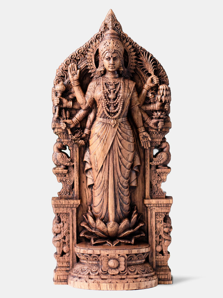 Handcrafted Dhanya Lakshmi statue with eight arms standing on lotus, holding grains, lotus flowers, mace, and displaying sacred mudras.