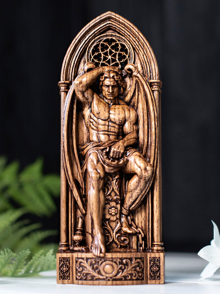 Occult Lucifer sculpture holding a crown with gothic architecture in the background, perfect for gothic home decor
