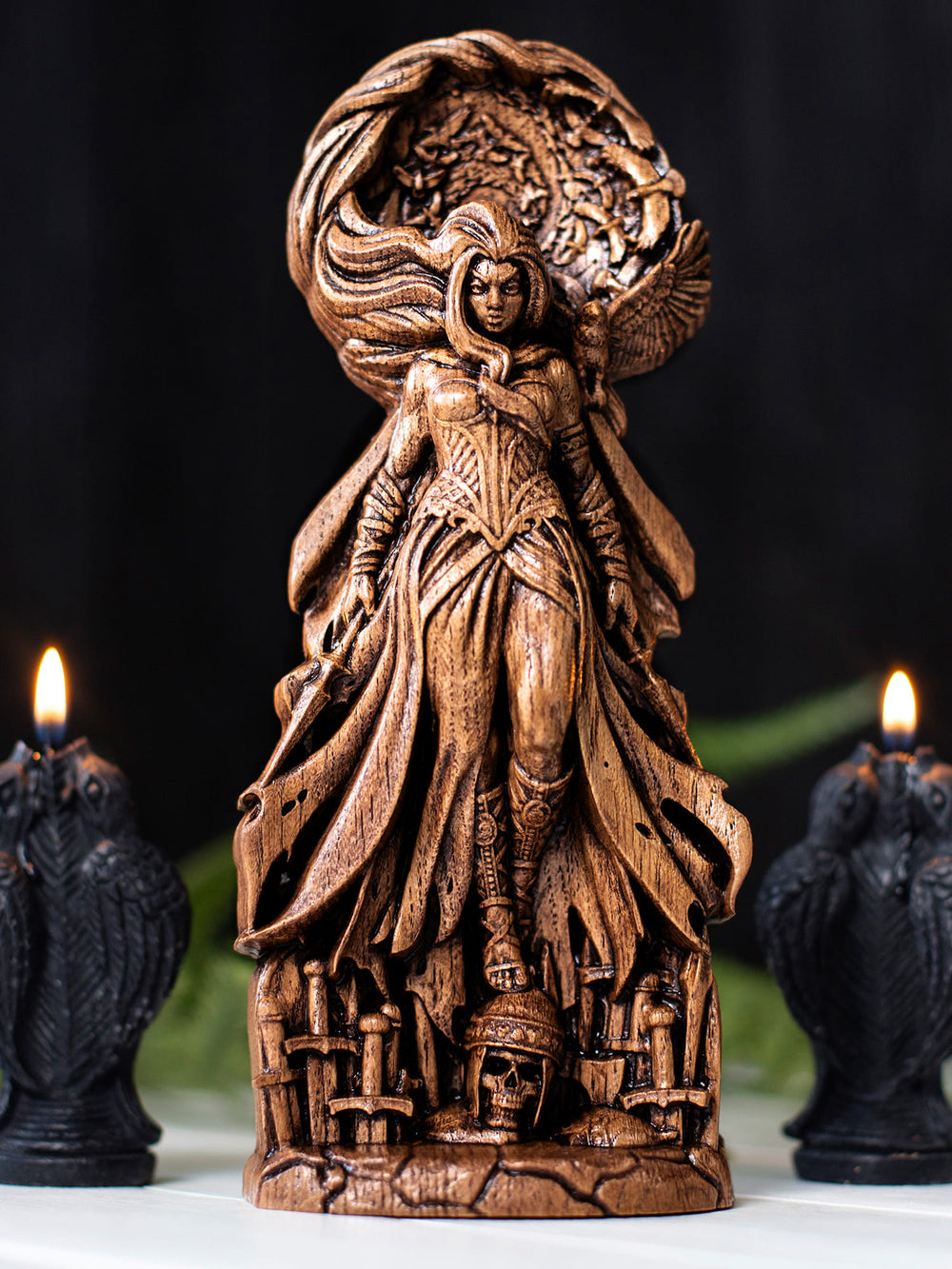 Wooden the Morrigan goddess statue with spiraling raven flock, fallen warrior skull, and dynamic Celtic battle imagery.