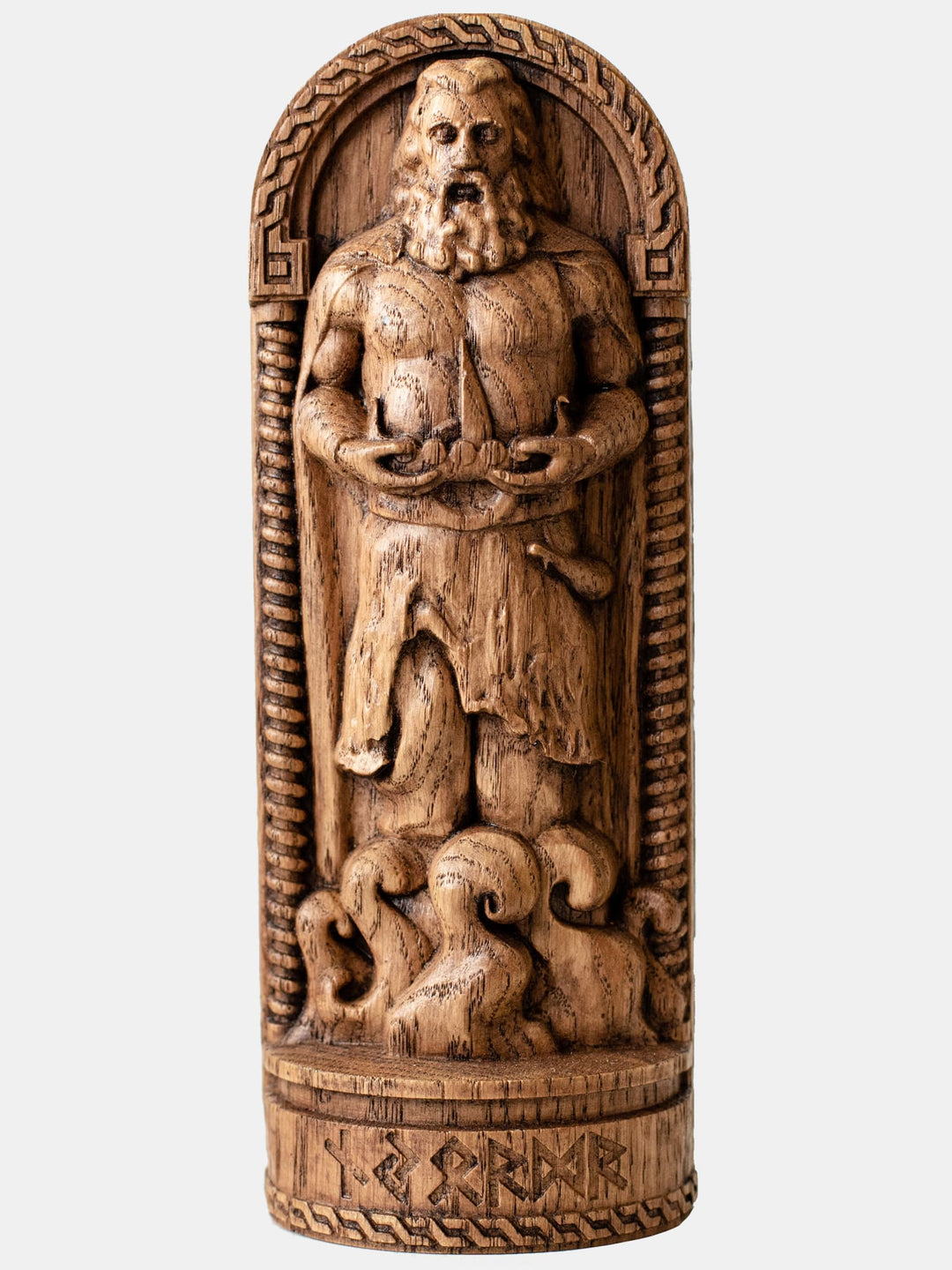 Close-up of the handcrafted oak Njord statue, showcasing the Norse Sea God standing among the waves and holding a drakkar in his hands.