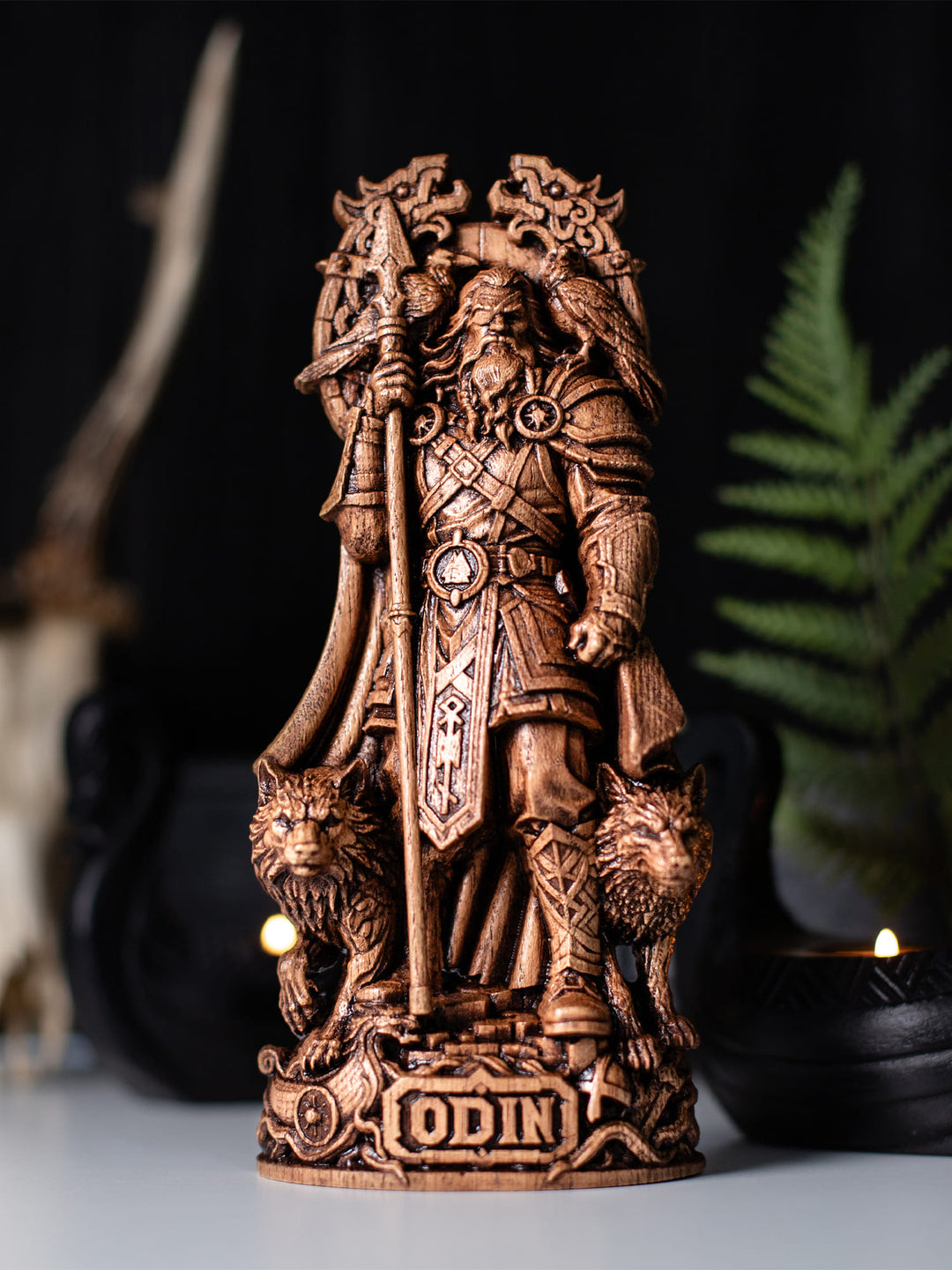 Handcrafted Odin wooden statue displayed on a tabletop, featuring ravens Huginn and Muninn, wolves Geri and Freki, Gungnir spear, Viking runes, and Norse mythology symbolism.
