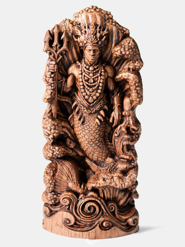 Handcrafted Olokun statue depicting Yoruba water deity rising from ocean waves with trident and coral crown.