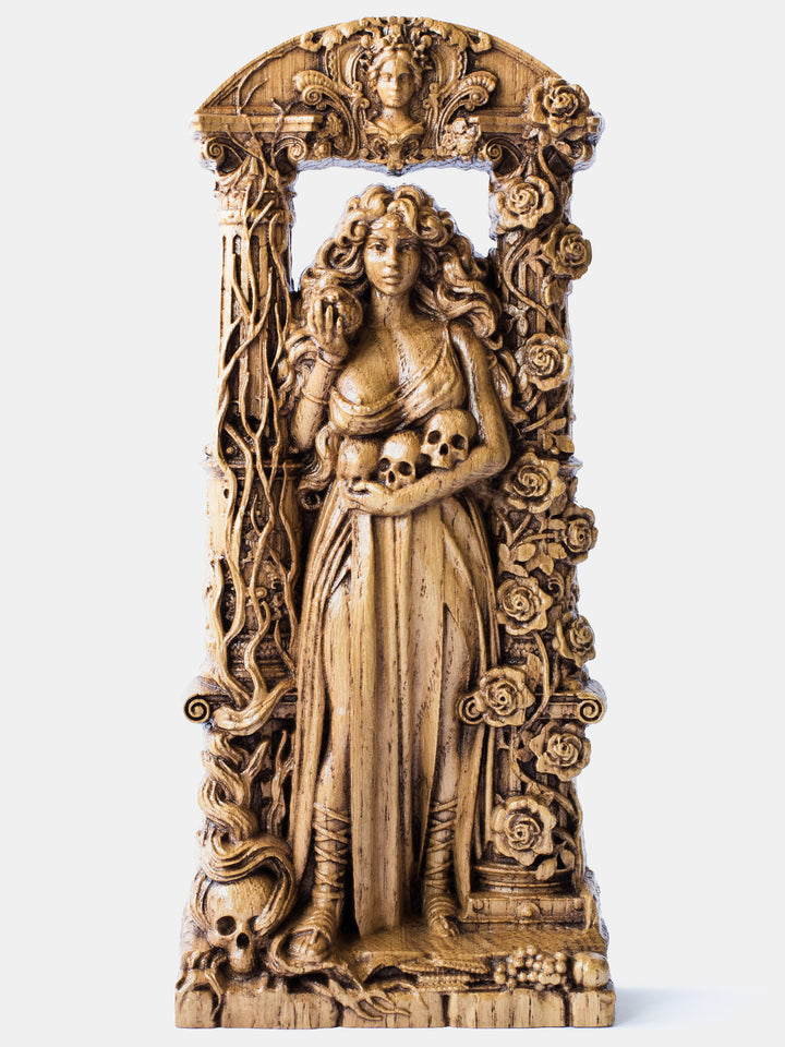 Close-up of the handcrafted oak Persephone statue, showcasing the goddess with a ruined column entwined with a withered vine and a bare chest.