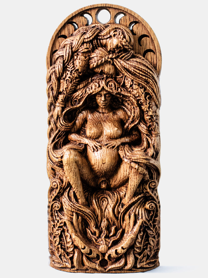 Full view of The Pregnant Goddess statue from the front, highlighting hands holding the sun, symbolizing midwives, doulas, and the natural world welcoming new life.