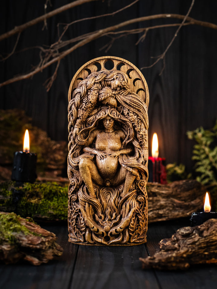 Full view of The Pregnant Goddess statue from the front, highlighting hands holding the sun, symbolizing midwives, doulas, and the natural world welcoming new life.