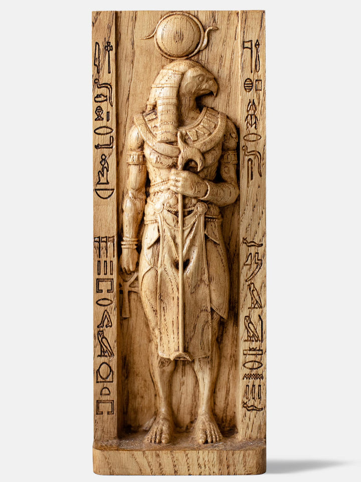Close-up of the handcrafted oak Ra statue, showcasing the Egyptian Sun God with the sun disk atop his head.