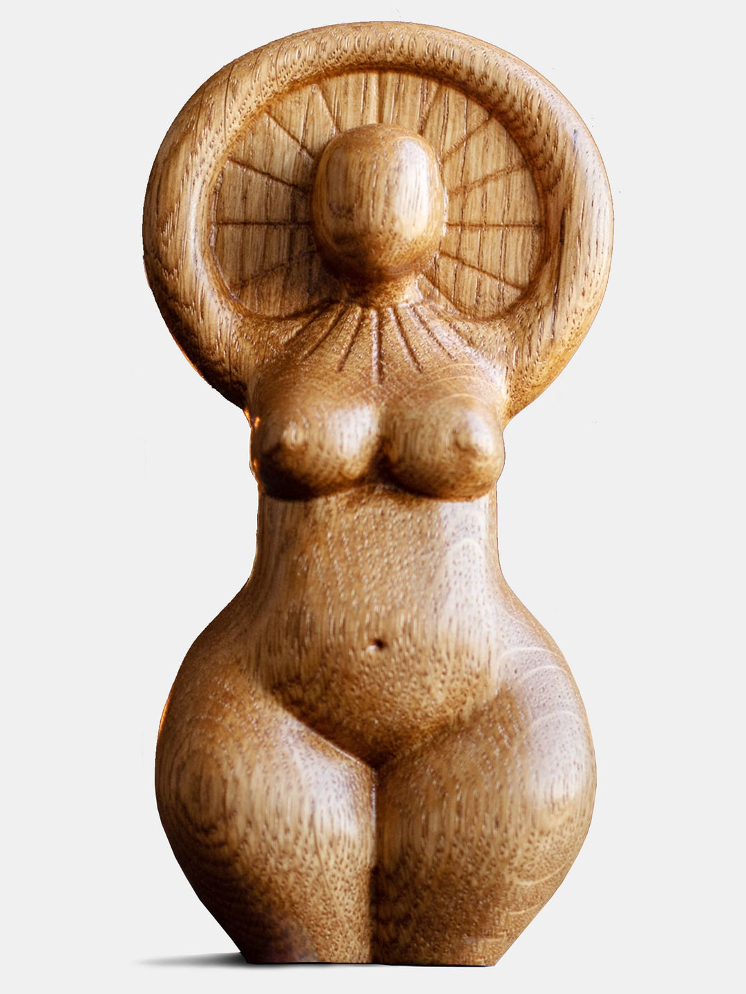 Close-up of the handcrafted oak Sun Goddess statue, showcasing the minimalist design and natural wood finish.