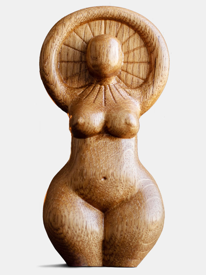 Close-up of the handcrafted oak Sun Goddess statue, showcasing the minimalist design and natural wood finish.