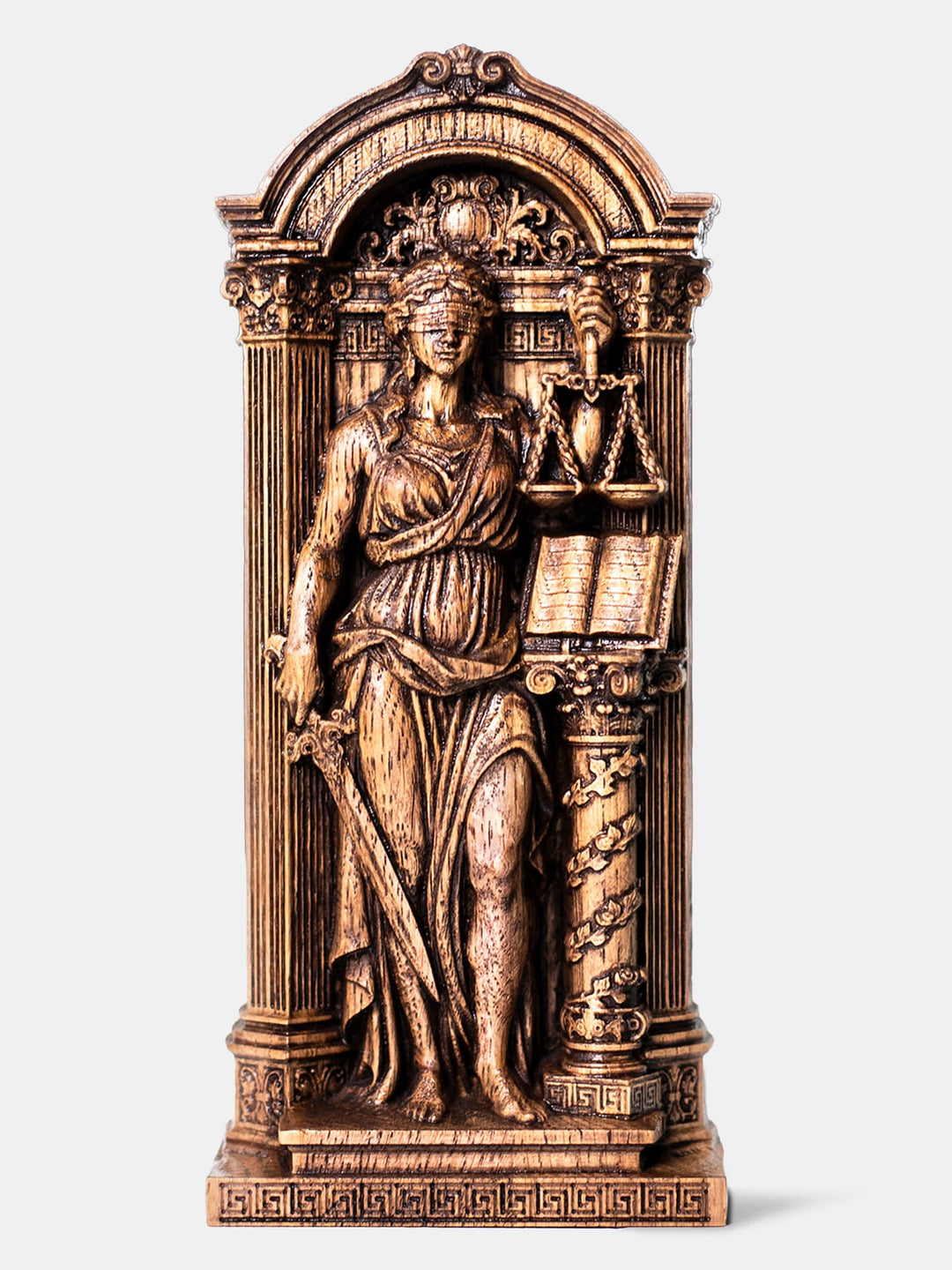 Handcrafted Themis statue with blindfold, holding scales and sword among ancient Greek architecture.