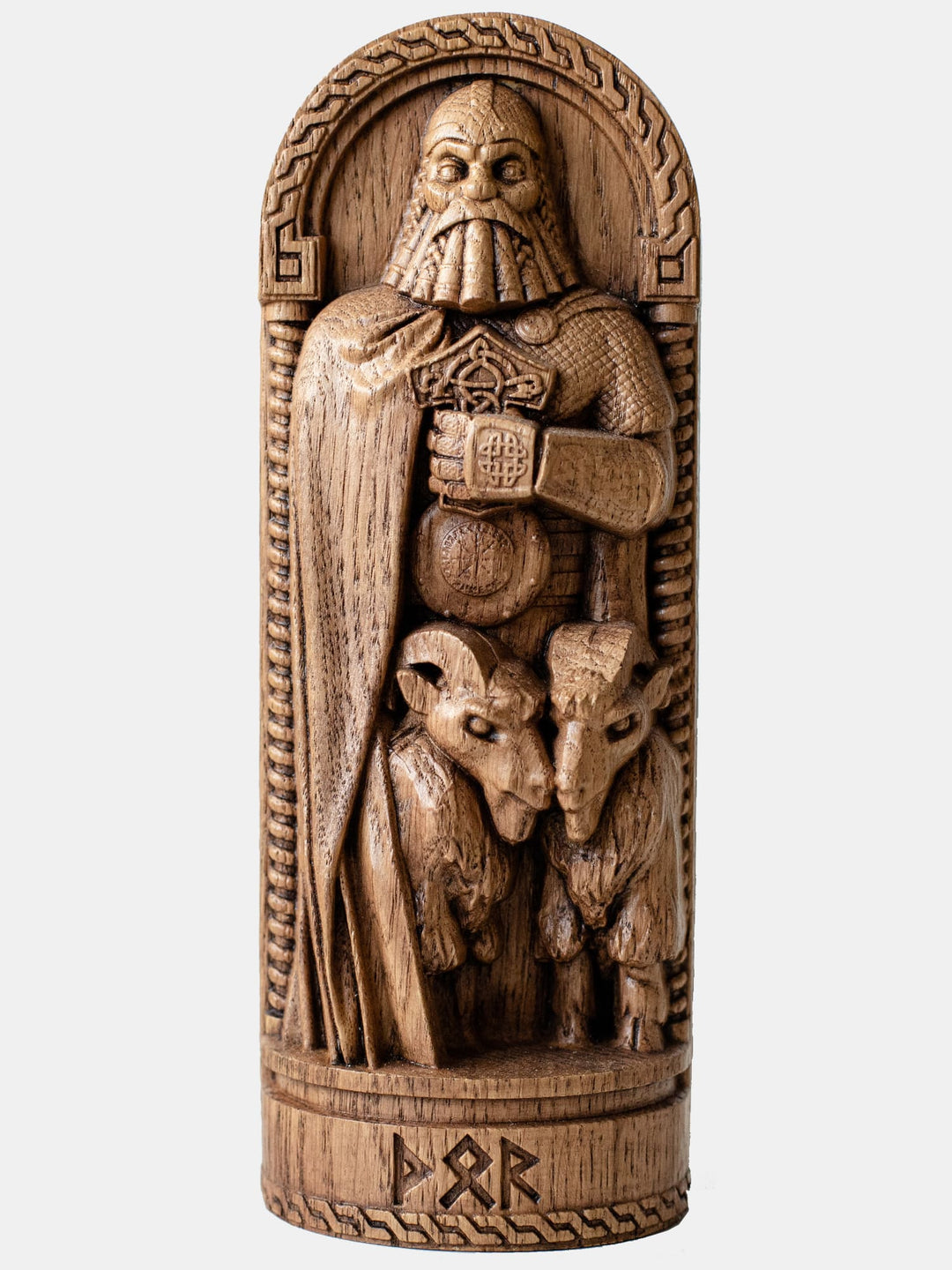 Close-up of the handcrafted oak Thor statue, depicting the Norse God of Thunder gripping his mighty hammer Mjölnir, with intricate carvings emphasizing his strength and warrior spirit.