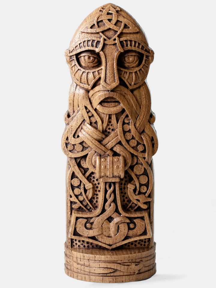 Close-up of the handcrafted oak Thor statue, showcasing the Norse God of Thunder holding his hammer, with magical gauntlets and belt.