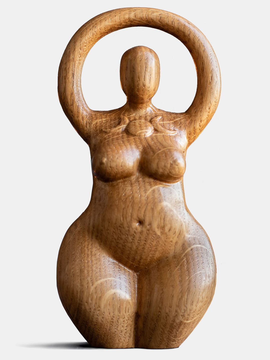 Close-up of the handcrafted oak Triple Goddess statue, showcasing the minimalist design with a triple moon symbol on her chest.